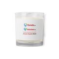 A clear glass jar candle with white wax and a white label featuring Donate.com and Volunteer.com - A Human Empathy Network